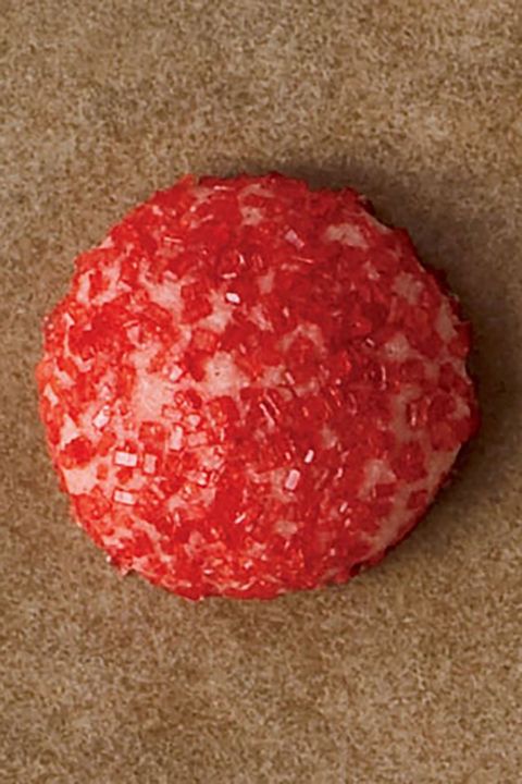 a cookie rolled in red sugar sprinkles