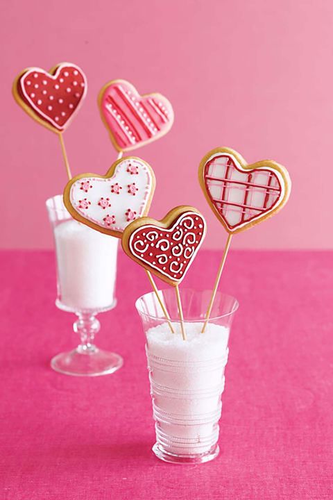 heart shaped cookies on sticks and arranged in small vases like boquets