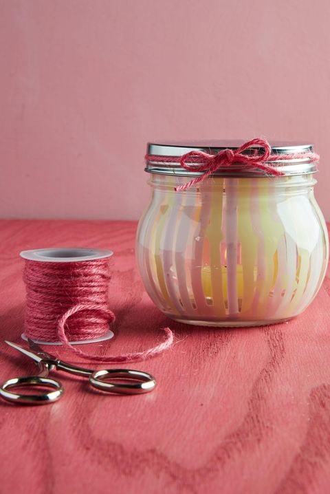 painted candle jar with string and scissors