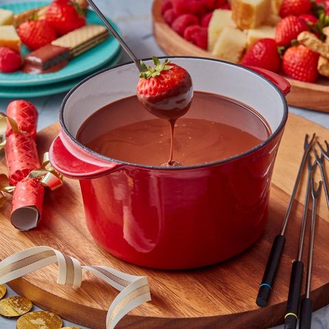 chocolate fondue with strawberry in red pot