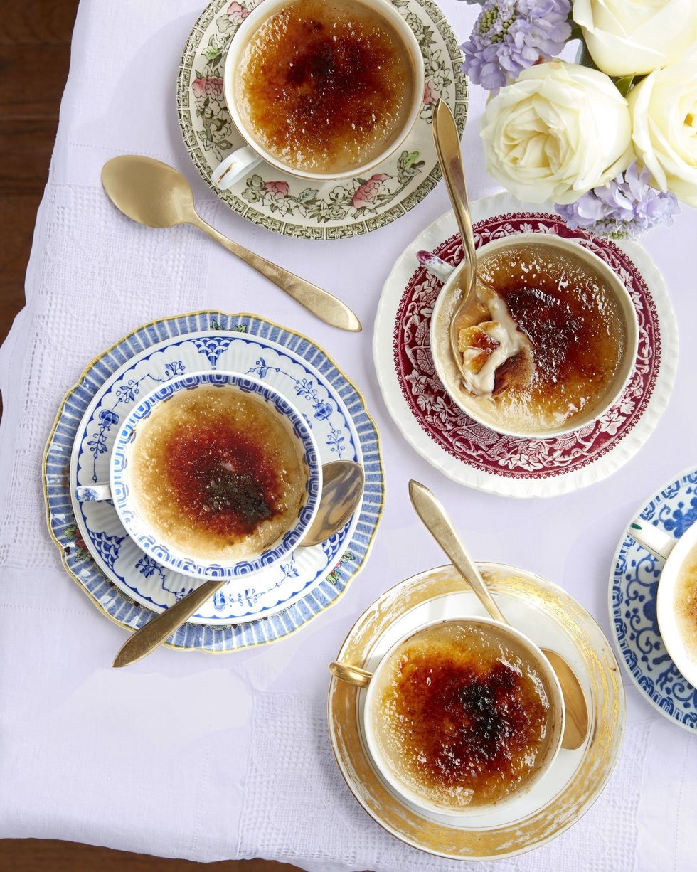 four teacups with earl grey creme brulee and gold spoons