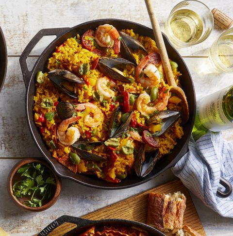 seafood and chorizo paella with bell peppers in a cast iron skillet