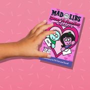 kids hands holding mad libs and stress relief bear