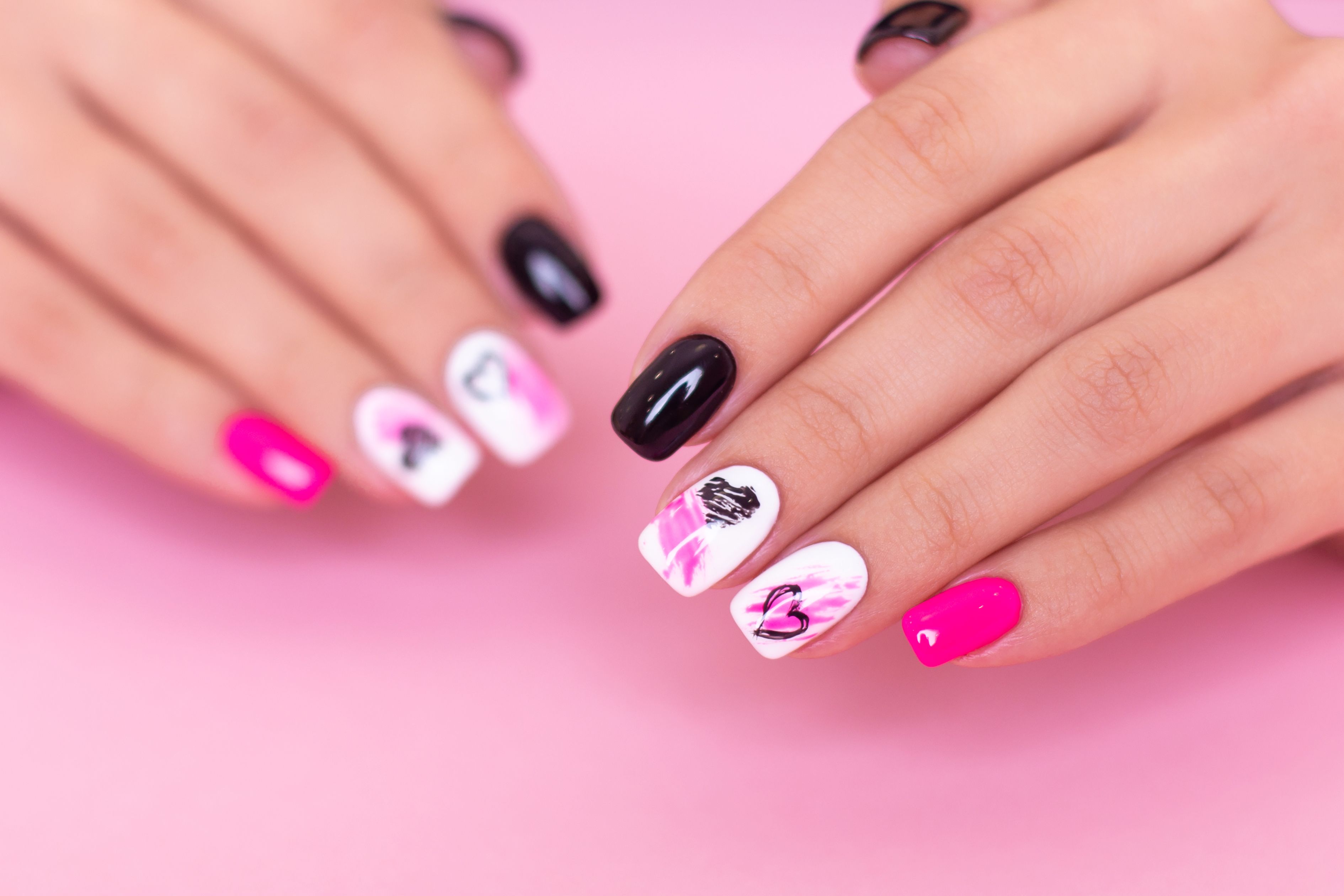 Premium Photo | Pink and black on nails young lady hands with manicured nail  art design pink color nails