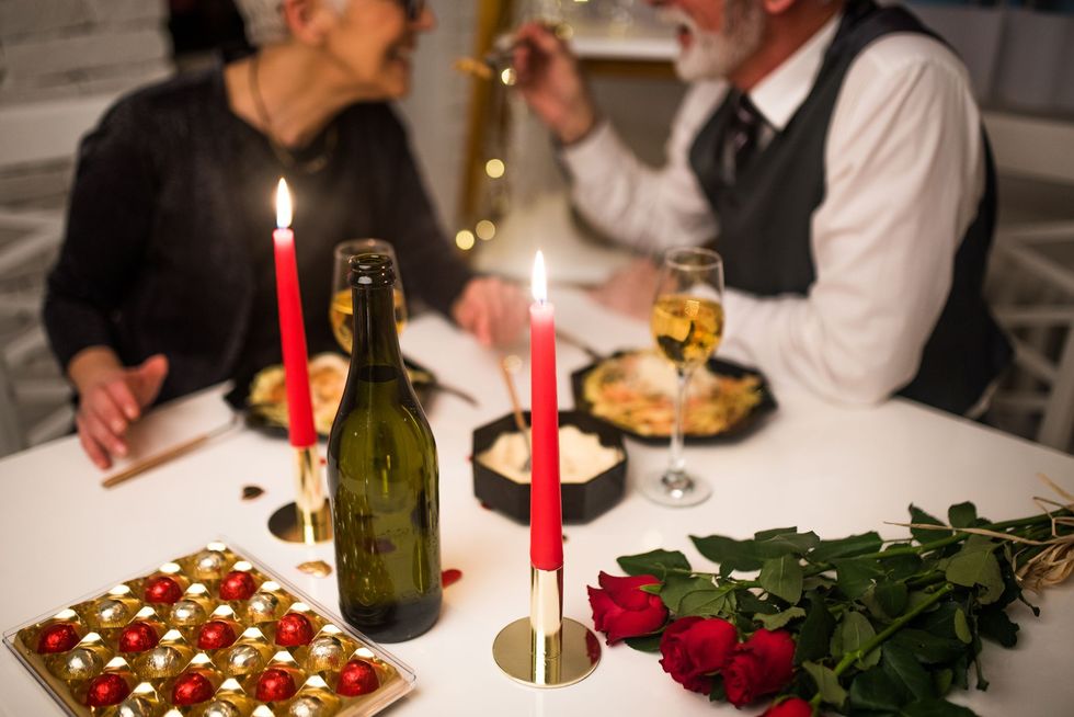 couple eating a romantic candlelit dinner