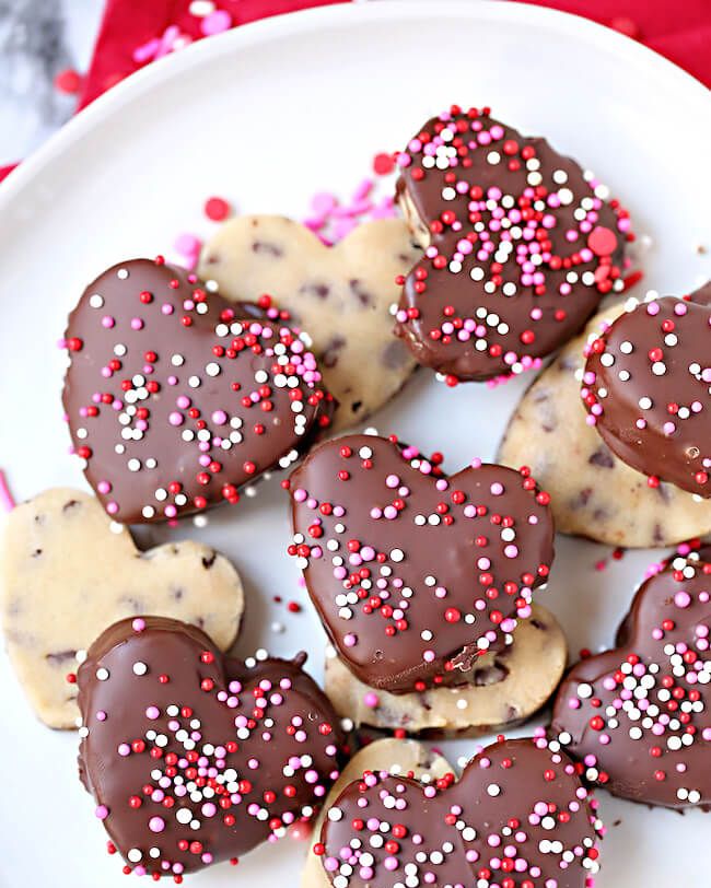 chocolate covered cookie dough hearts with pink and red sprinkles