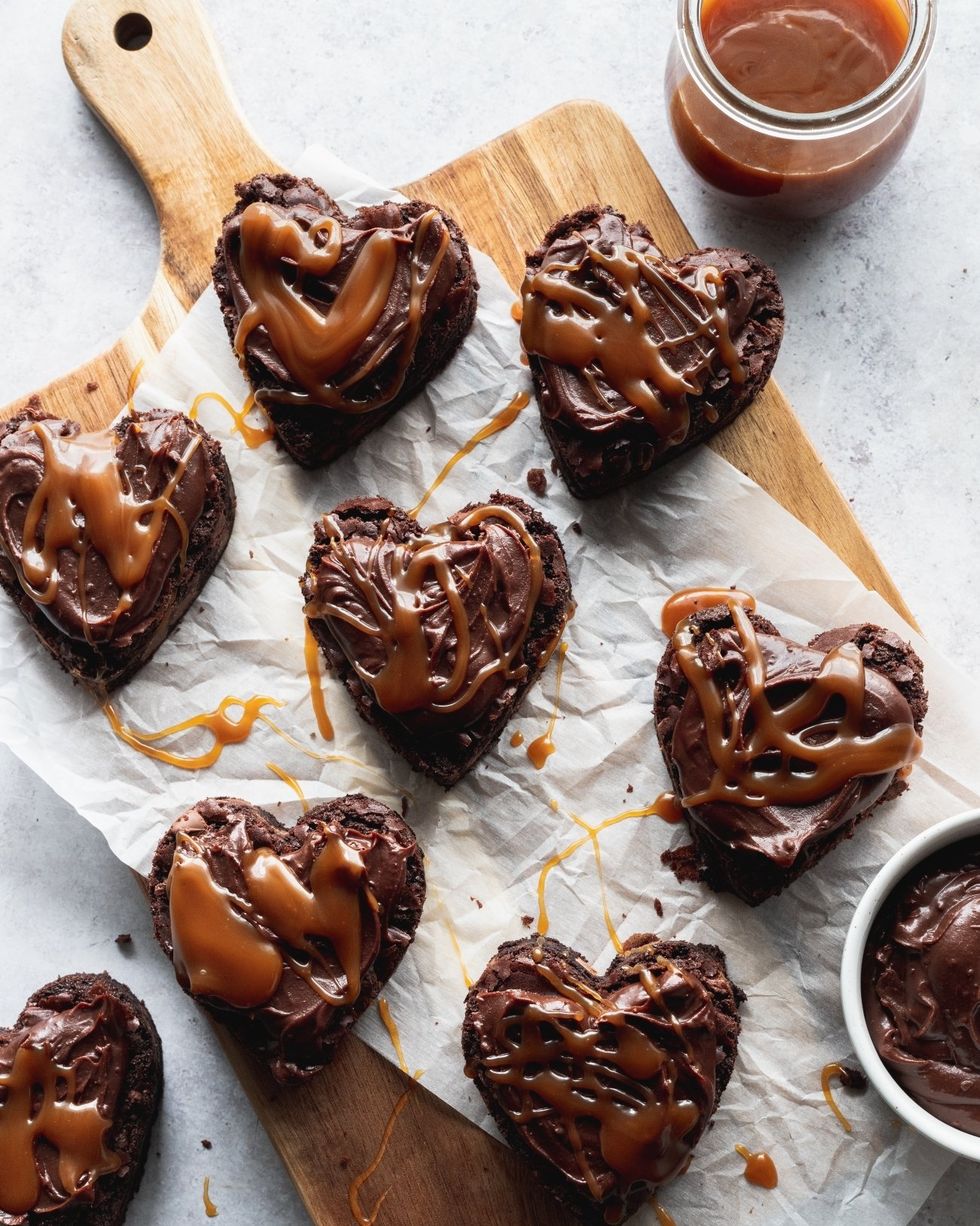heart shaped brownies with caramel on wood board