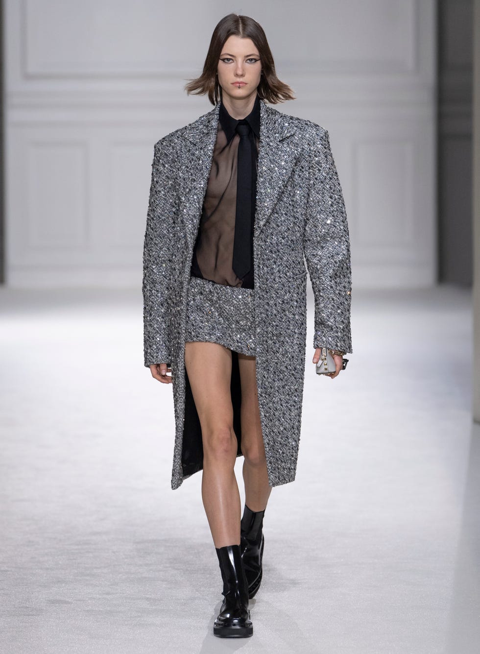 a woman dressed in a coat and boots