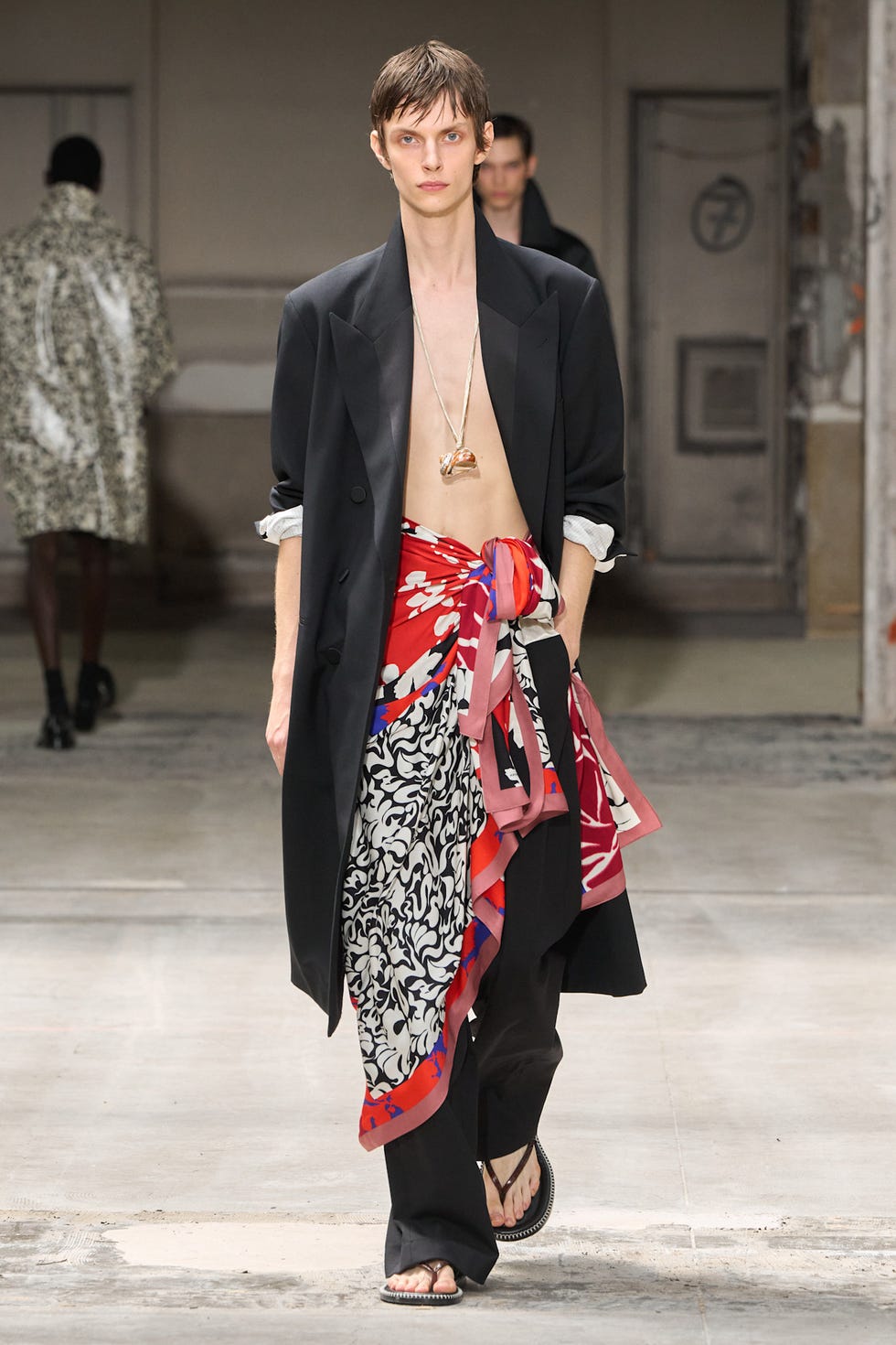 Fashion model showcasing a unique outfit during a runway show
