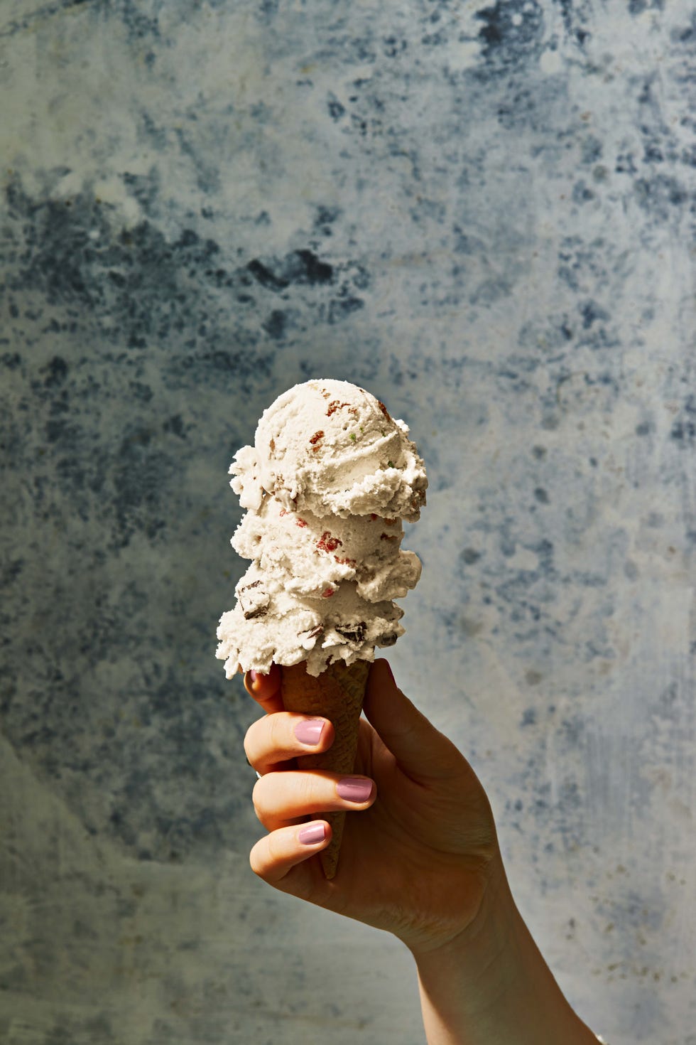 three scoops of vanilla ice cream on a sugar cone