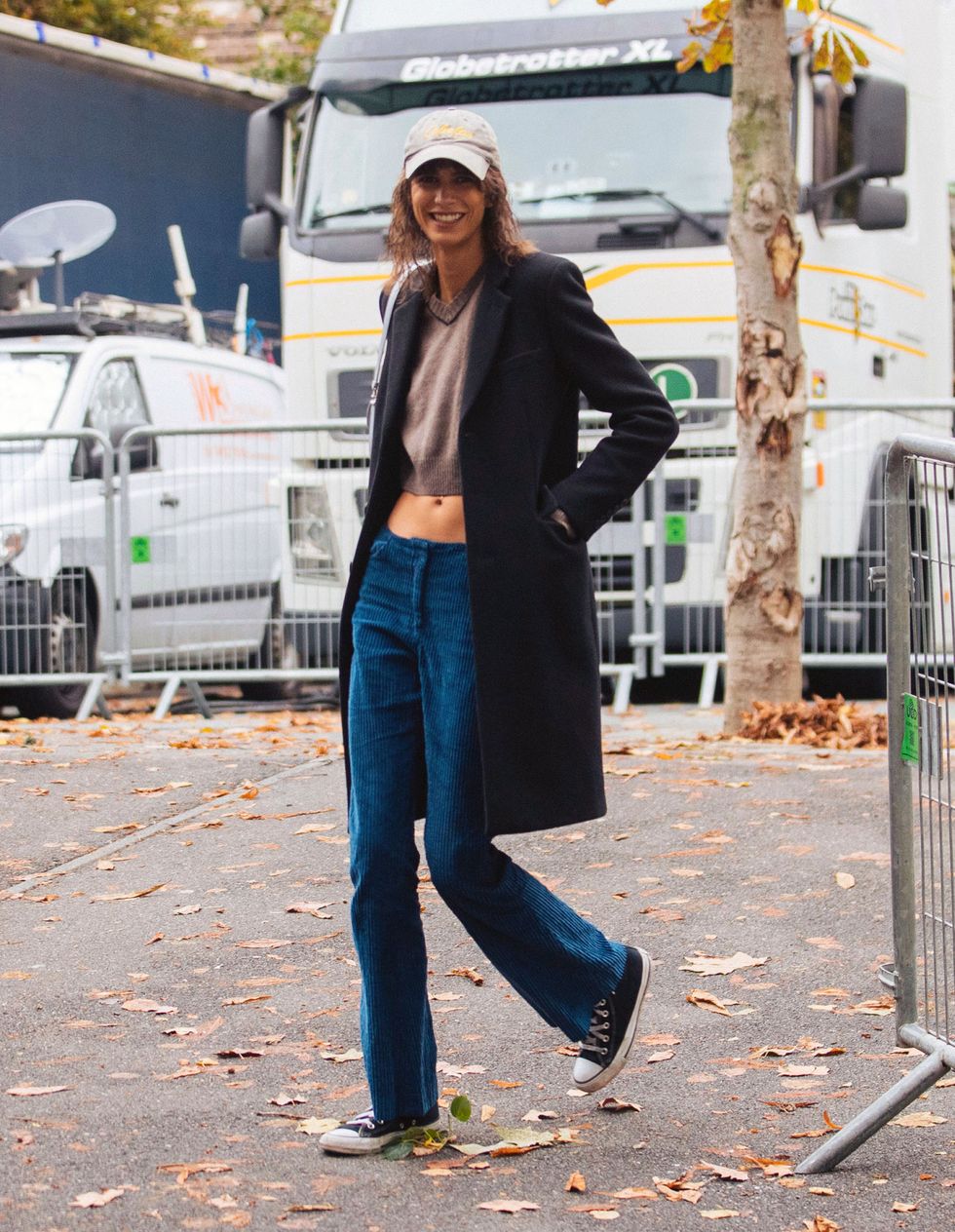 paris, france   october 03 model mica arganaraz wears a gray cabela's club cap, black peacoat, light brown croptop, blue jeans, and black converse sneakers after the ann demeulemeester show on october 03, 2021 in paris, france photo by melodie jenggetty images