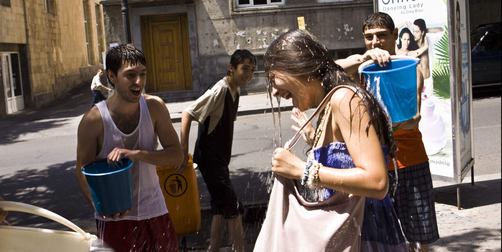 two boys throwing water at girl in armenia for vardavar