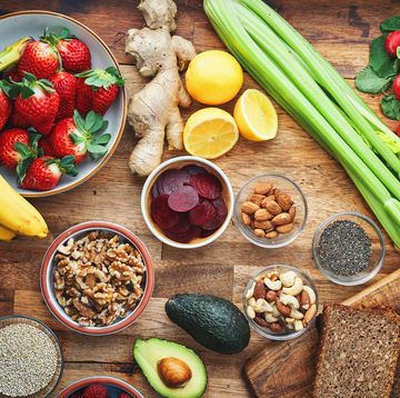 variation of healthy superfoods with fresh fruits, vegetables, nuts, seeds, and whole grains