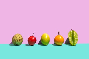 variation of tropical fruits on a rose turquoise background