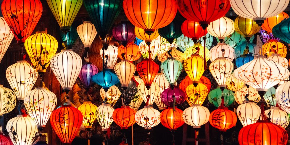 various illuminated paper lanterns hanging at night for celebrating chinese new year