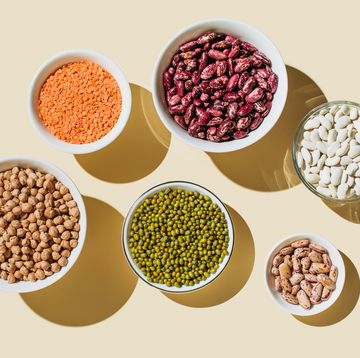 various kinds of vegan protein sources on beige background nuts and legumes green mung beans, chick pea, red lentil, kidney bean, almonds, hazelnuts flat lay, top view