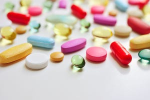 various pills lying on a white surface