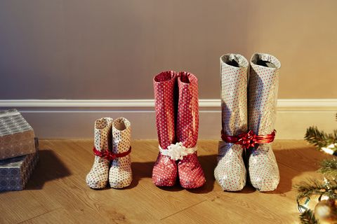 various sized boots wrapped as christmas presents