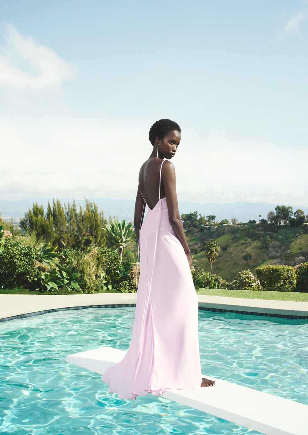 a man in a dress standing in a pool