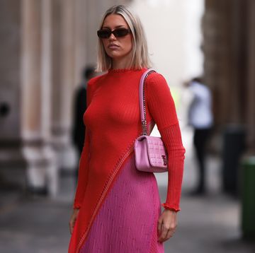 a woman wearing a pink dress and sunglasses