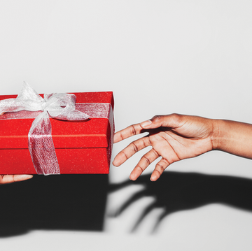a hand giving another hand a gift