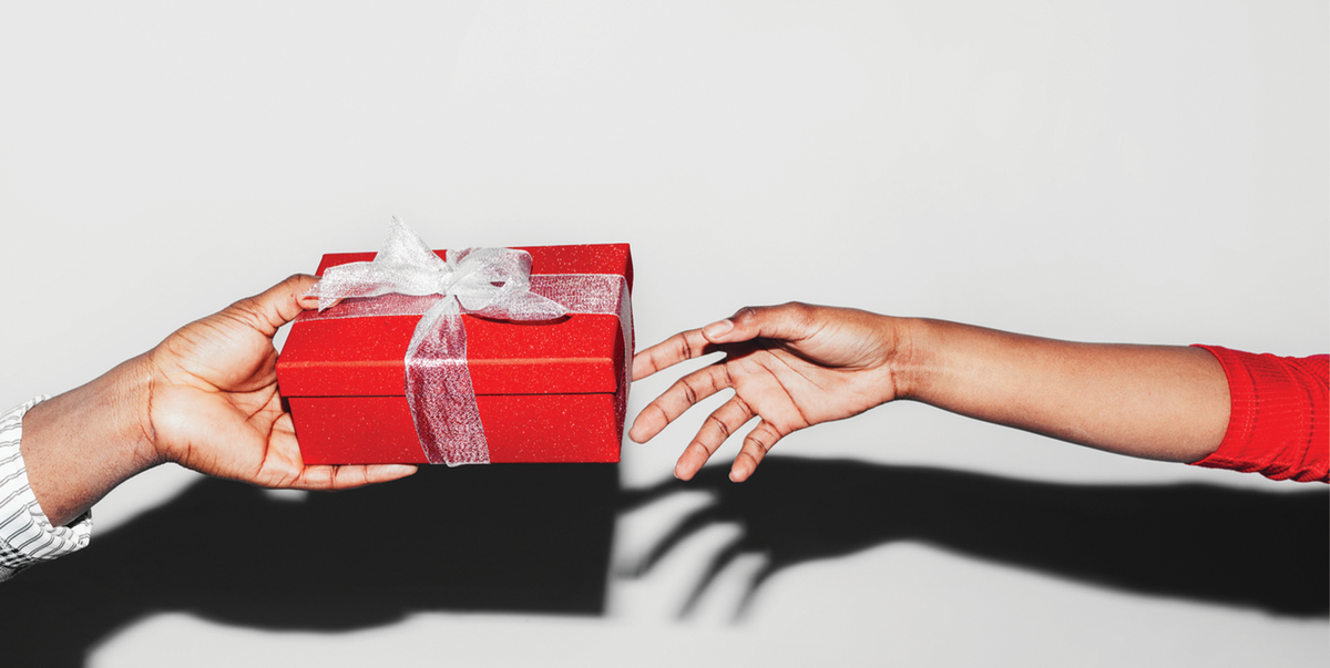 a hand giving another hand a gift