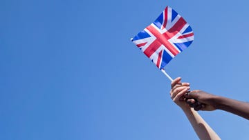 two children from different ethic backgrounds hold the union jack together.