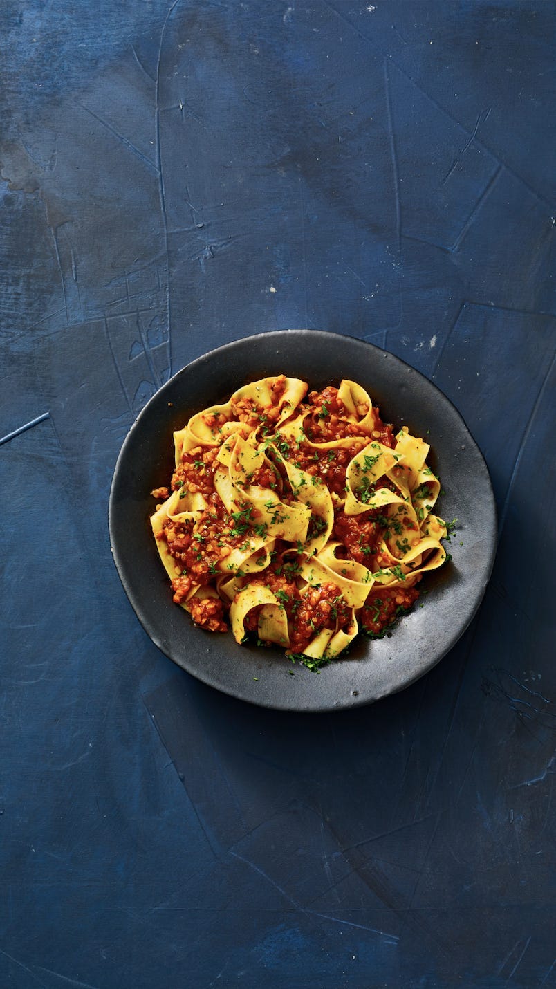 vegan bolognese with pasta in a black bowl