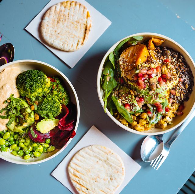vegan bowls with various vegetables and seeds, high angle view