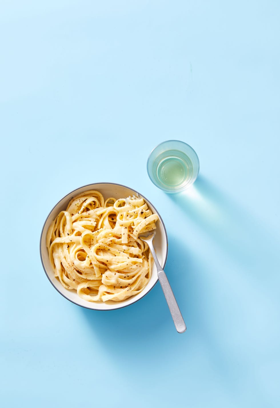 cauliflower alfredo in a bowl with a fork