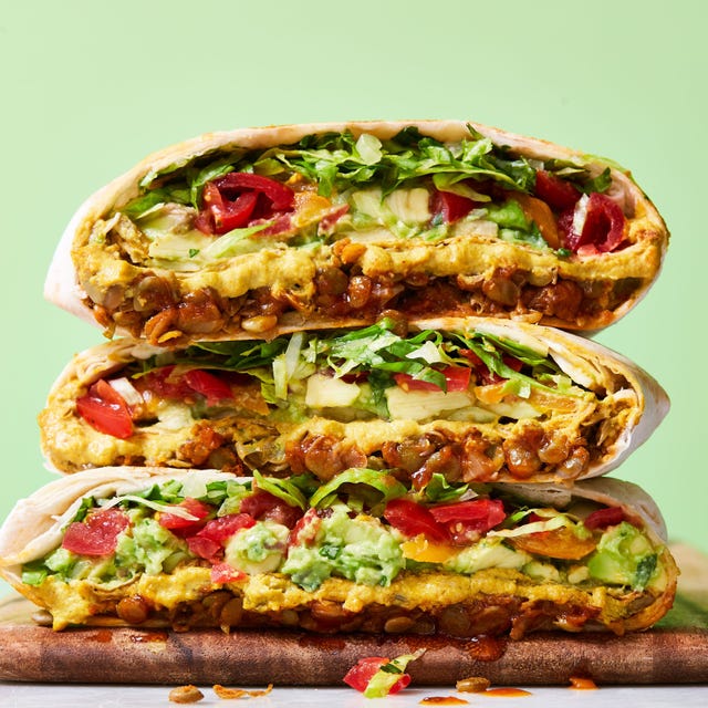 vegan crunchwrap supreme filled with cooked lentils, avocado, tomatoes, and vegan cheese sauce