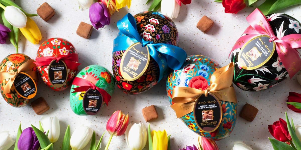 Booja-Booja vegan easter eggs wrapped in ribbons surrounded by tulips