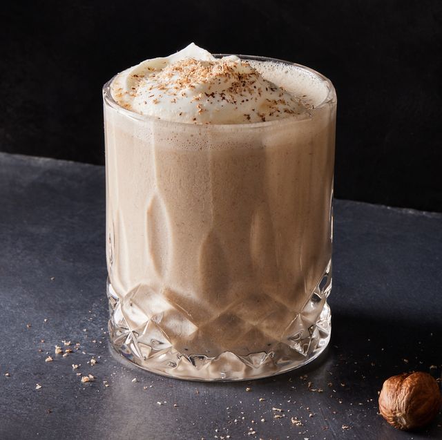 vegan eggnog topped with soy whipped cream and grated nutmeg
