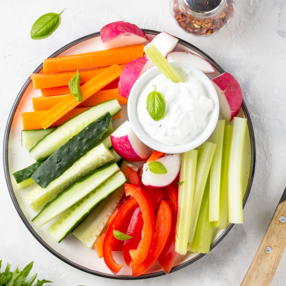 mediterranean diet vegetable sticks of cucumber pepper carrots celery and radishes with yogurt dip