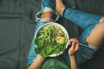 vegetarian breakfast bowl with spinach, arugula, avocado, seeds and sprouts