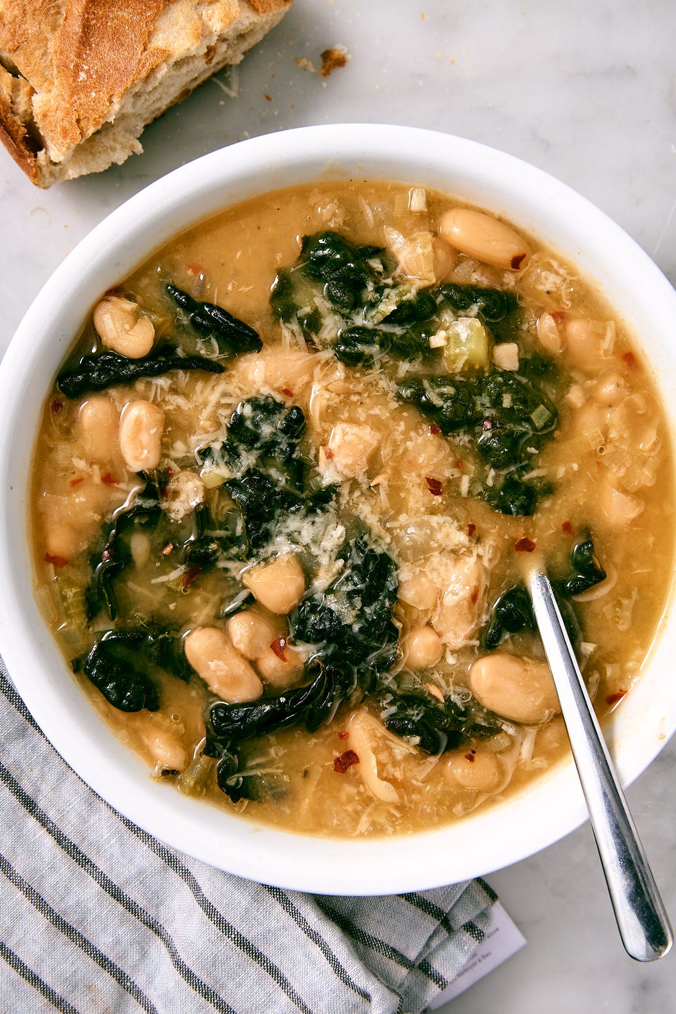 vegetarian kale white bean soup topped with parmesan and red pepper flakes