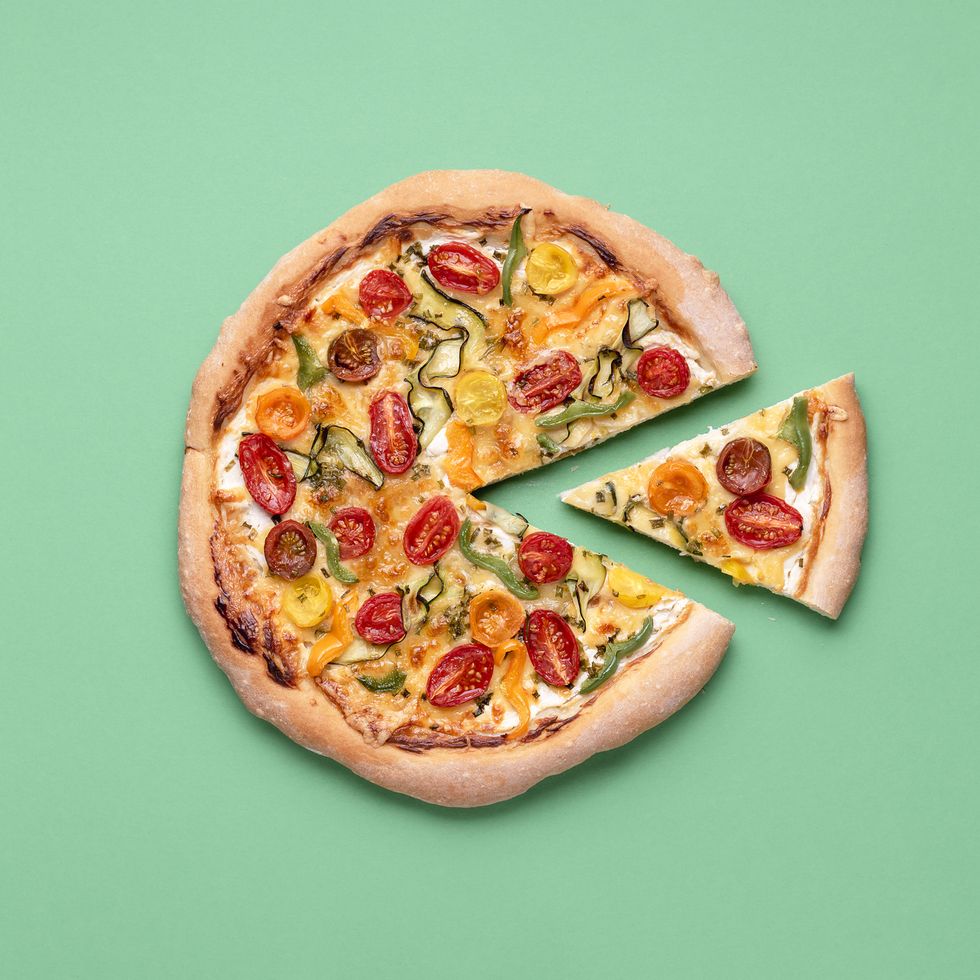 vegetarian pizza on a green background pizza primavera and just one slice single slice of pizza