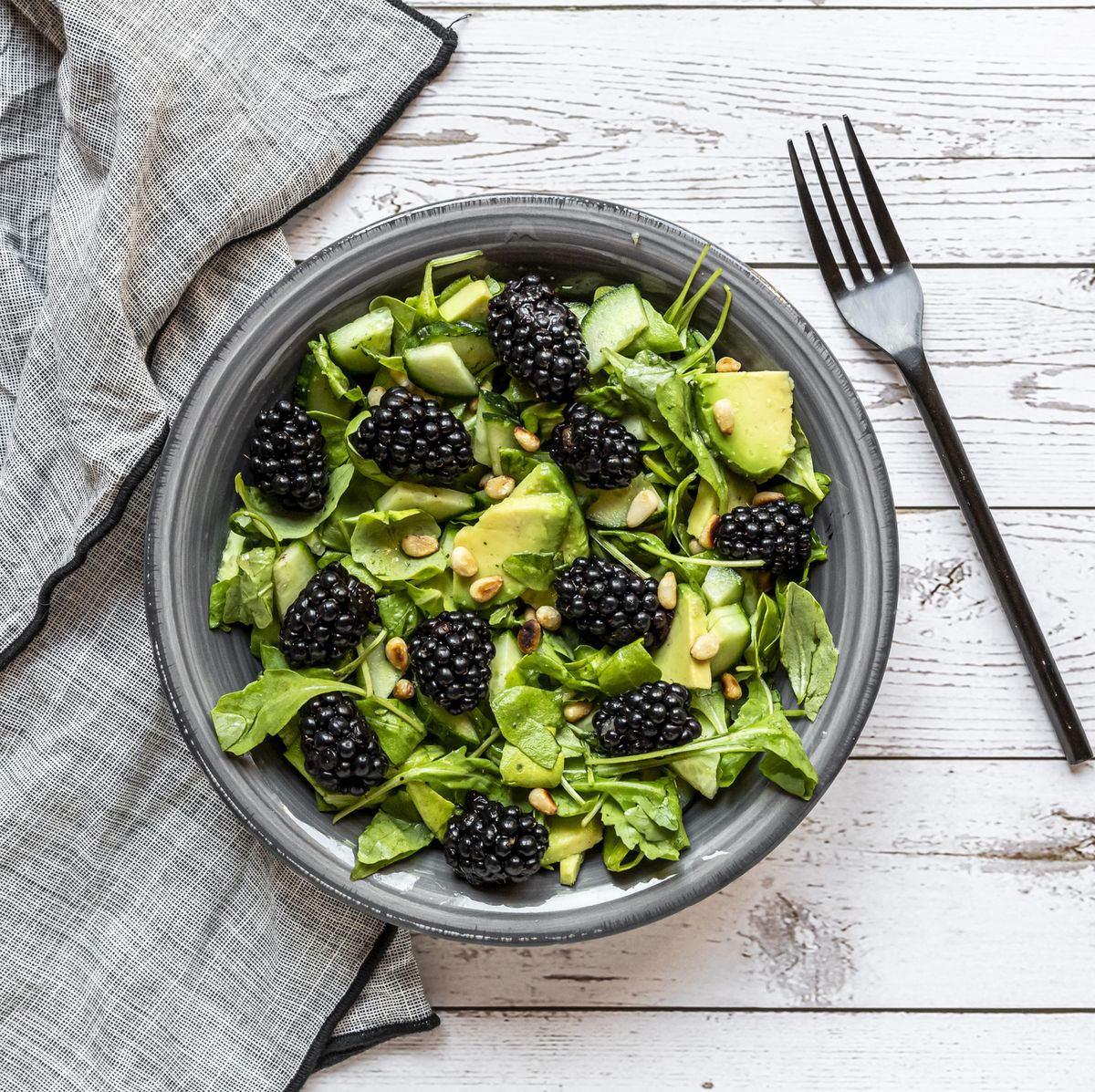 raw food diet vegetarian salad with arugula, avocado, cucumber and blackberries