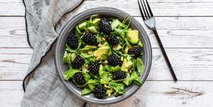 raw food diet vegetarian salad with arugula, avocado, cucumber and blackberries