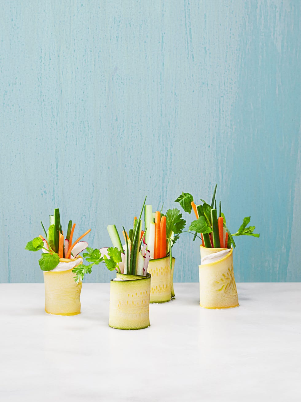 veggie matchsticks wrapped up in yellow and green squash ribbons