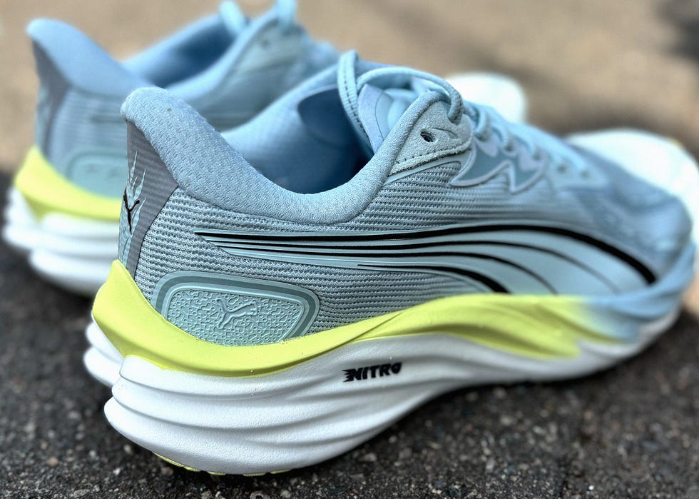 close up of the heel of a blue and yellow running shoe