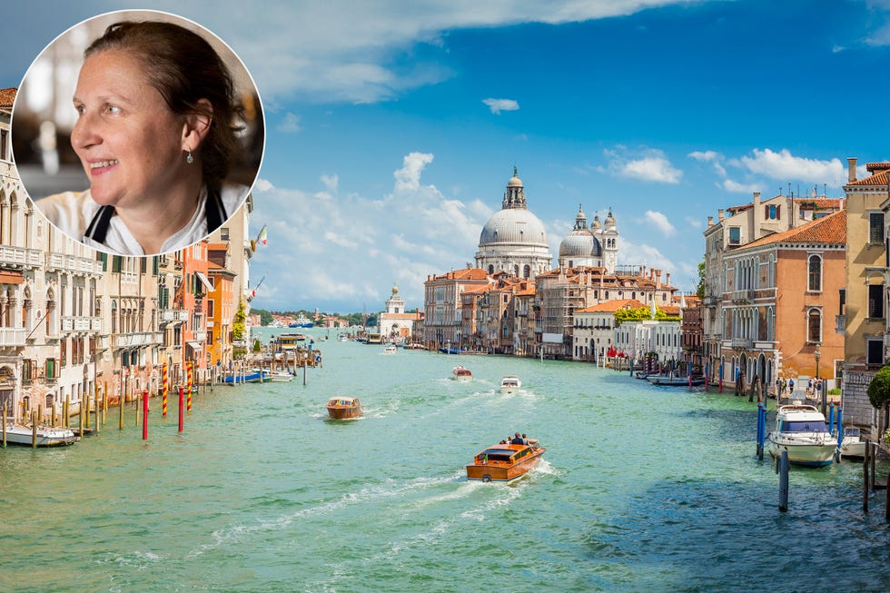 an iconic view from accademia bridge italian ponte dell'accademia in venice numerous boats and vessels are seen cruising along the grand canal on a bright sunny day santa maria della salute is seen in background