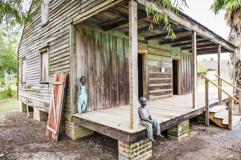 he original cypress slave cabins at whitney plantation were destroyed in the 1970s but have since been replaced with cabins from nearby plantations the figures on the porch were erected as part of the children of whitney