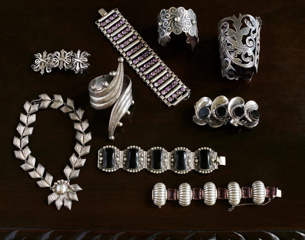 a selection of very old unmarked mexican cuffs, bracelets, and a necklace with designer pieces by antonio pineda center right, fred davis lower right, and los castillo taller upper left