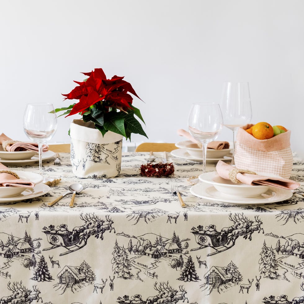 Christmas table with verdonce textiles a table with plates and glasses