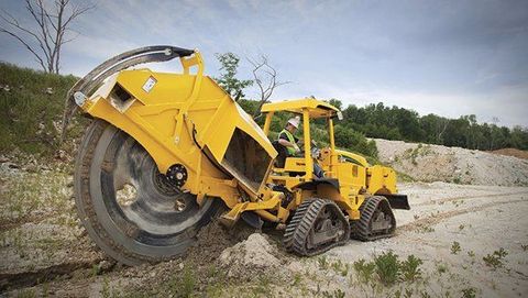 Land vehicle, Vehicle, Construction equipment, Yellow, Bulldozer, Soil, Wheel, Automotive tire, Tree, Tire, 