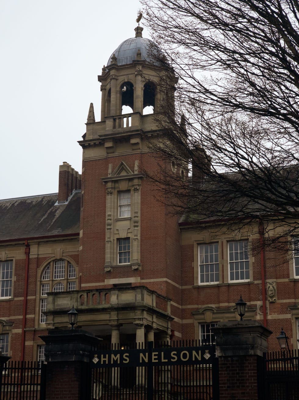 vertical sH๏τ of hms nelson building with a bell tower on top in portsmouth, uk