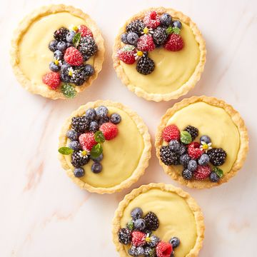 cream tartlets with mixed berries on top