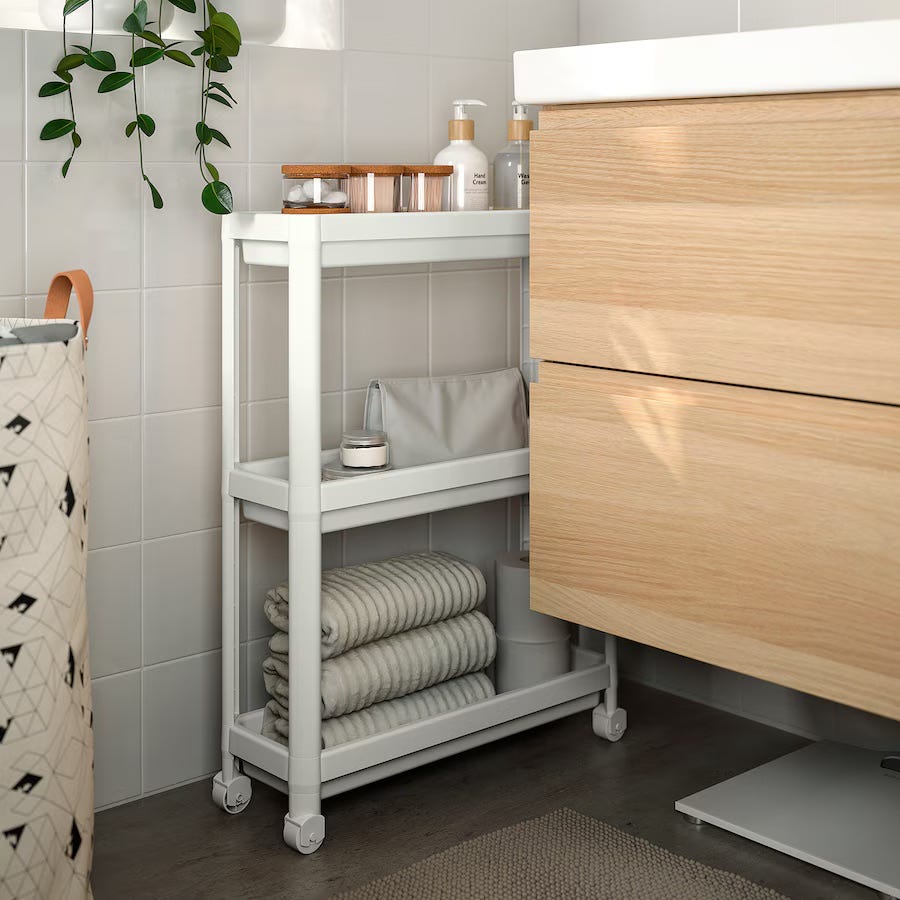 bathroom storage unit with towels and toiletries