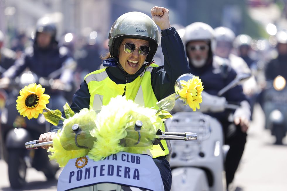 a person in a helmet holding flowers